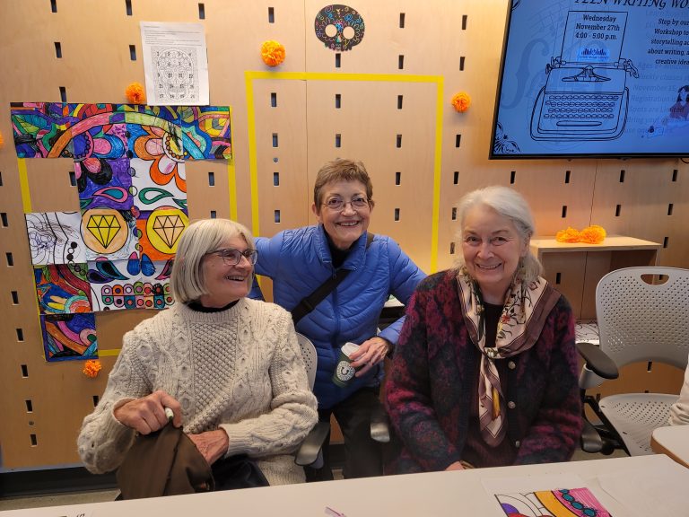 Friends of the Library posing for a photo during Dia de los Muertos 2024